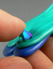 Bead being pressed into clay